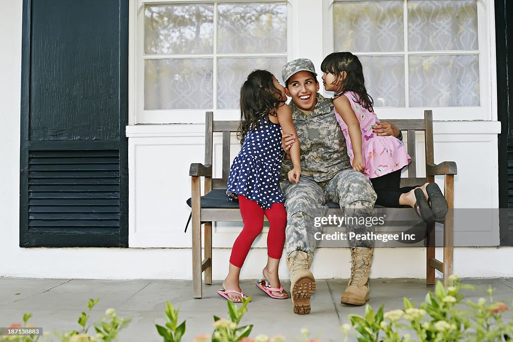 Soldier mother with daughters on patio