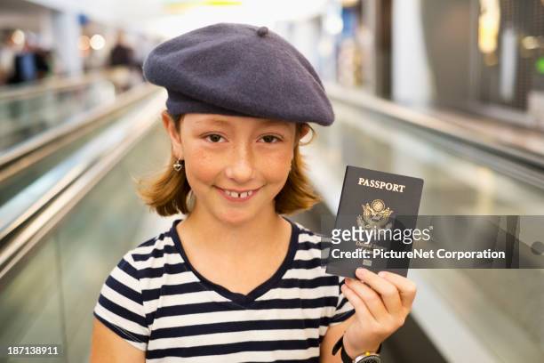 caucasian girl holding passport in airport - portraits of people passport fotografías e imágenes de stock