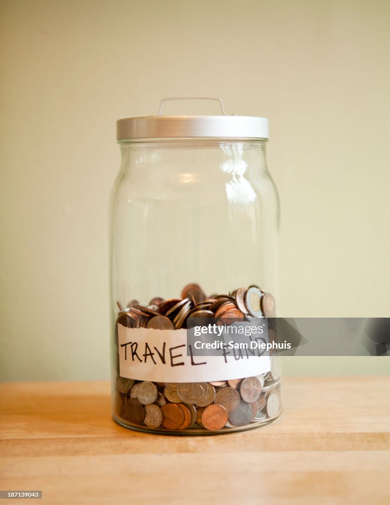 Coins in 'travel fund' jar