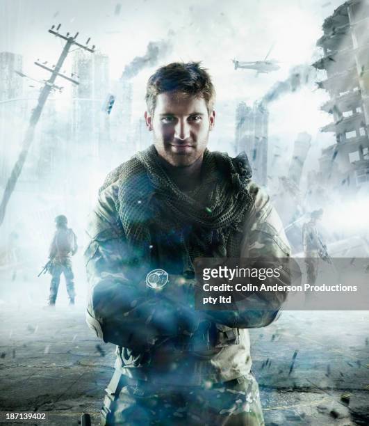 caucasian soldier standing in combat zone - heroes stock-fotos und bilder