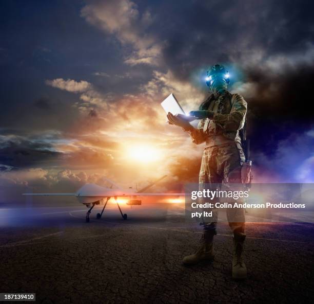 caucasian soldier using laptop in combat zone - intellectual ventures stock pictures, royalty-free photos & images