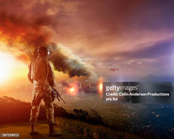 caucasian soldier overlooking combat zone - conflict stock pictures, royalty-free photos & images