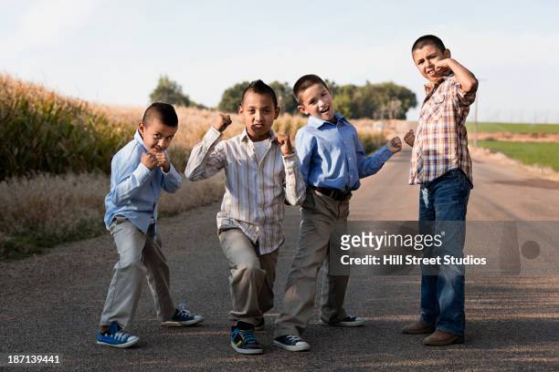 boys posing together on rural road - machismo imagens e fotografias de stock