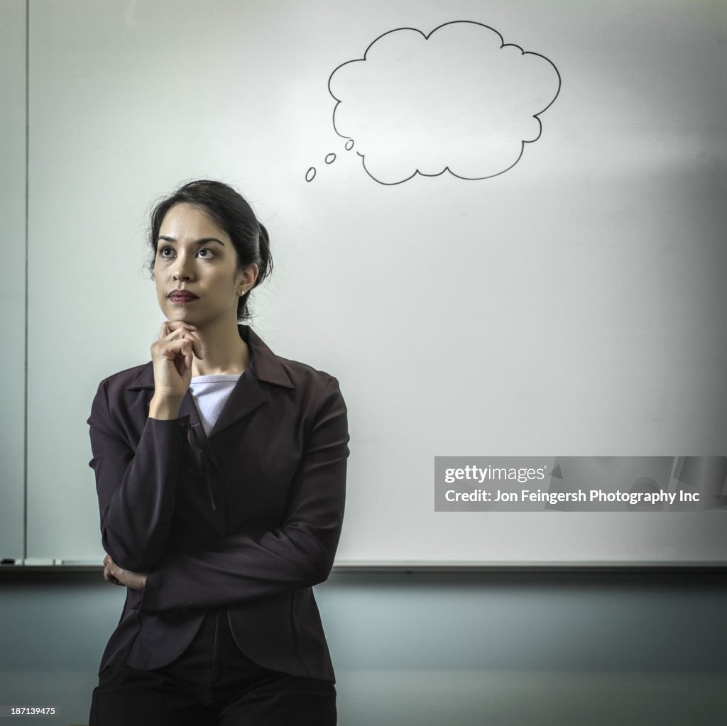 Filipino businesswoman with thought bubble in office