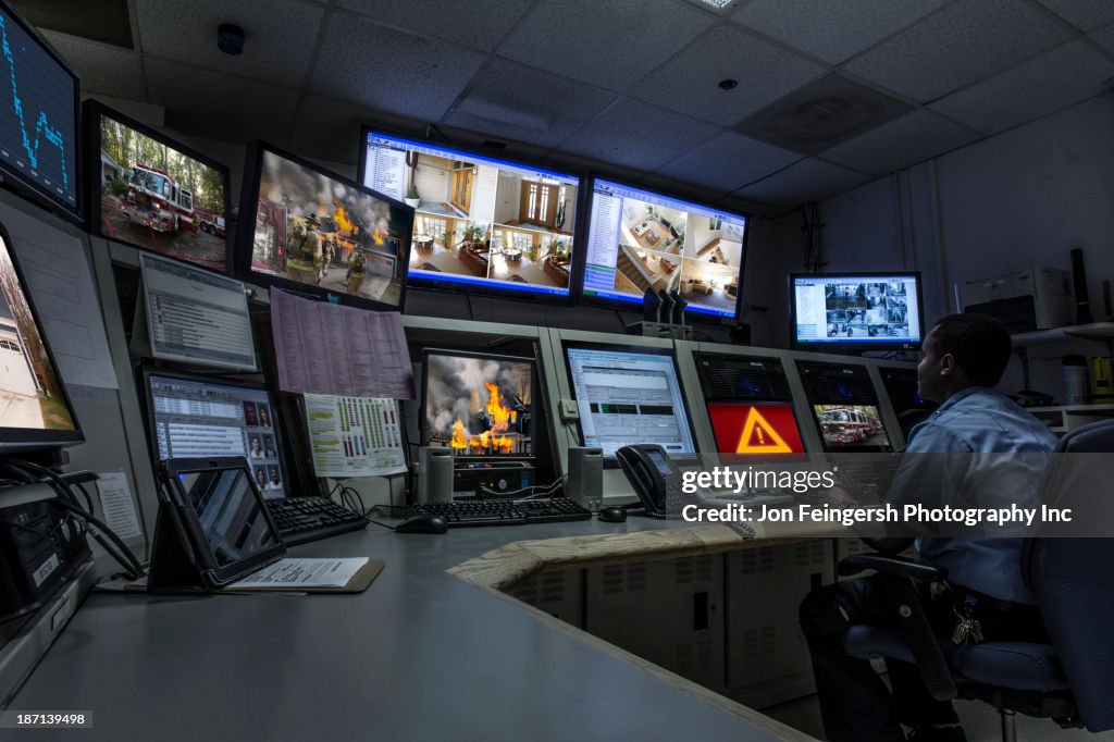 African American security officer working in control room