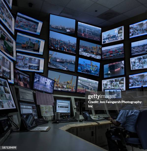african american security officer working in control room - sala de controlo imagens e fotografias de stock