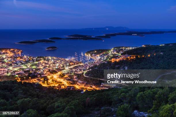 illuminated city skyline at dusk, hvar island, croatia - hvar croatia stock pictures, royalty-free photos & images