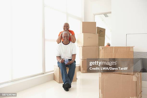 black couple smiling in new home - first gray hair stock pictures, royalty-free photos & images