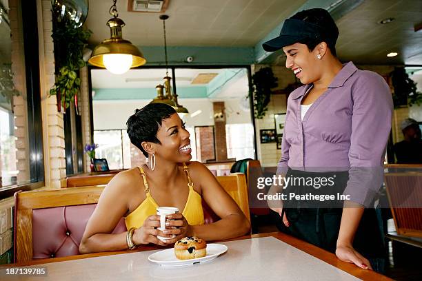 waitress talking to customer in restaurant - waitress booth stock pictures, royalty-free photos & images