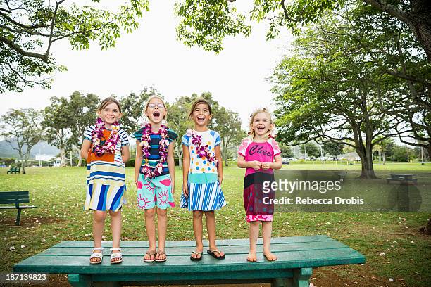 Girls standing together on picnic table