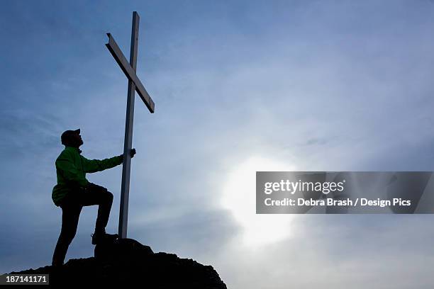 a man looks up at cross located at the top of mt. tzouhalem in the cowichan valley - cowichan bay stock pictures, royalty-free photos & images