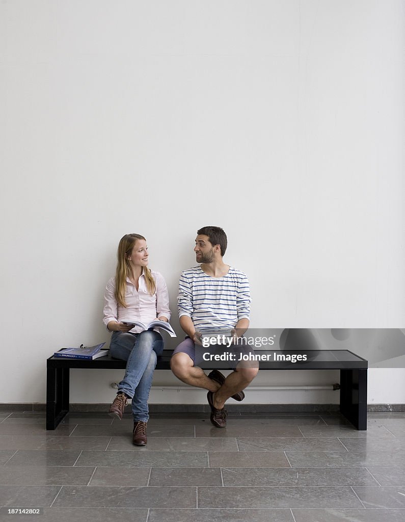 Young students sitting on bench