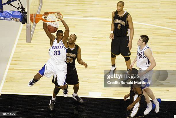 Bryant Nash of Kansas dunks in front of Arthur Johnson of Missouri during the semifinals of the Big XII Championships at the American Airlines Center...