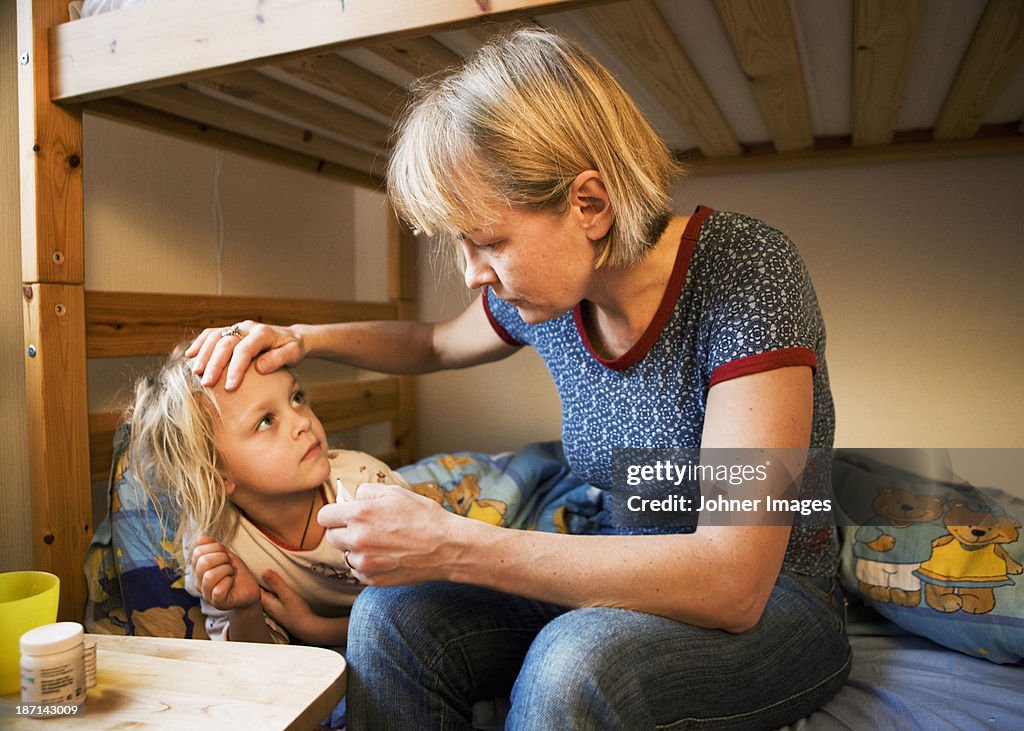 Mother taking care of sick daughter, Sweden.