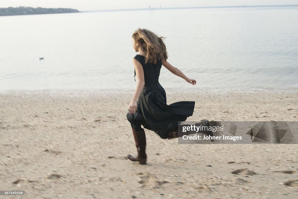 Young woman running on beach