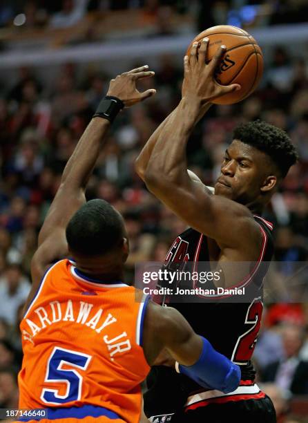 Jimmy Butler of the Chicago Bulls looks to pass over Tim Hardaway Jr. #5 of the New York Knicks at the United Center on October 31, 2013 in Chicago,...