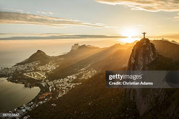 view of corcovado and rio de janeiro at sunset - cristo redentor stock pictures, royalty-free photos & images