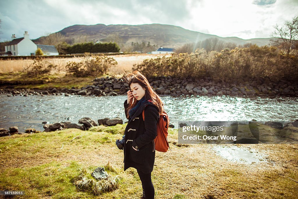 A young girl is hiking alone