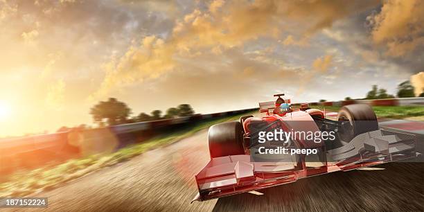 racing car at speed in summer sunset - grand prix motor racing stock pictures, royalty-free photos & images