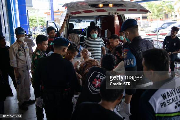Chinese worker who was injured in the explosion at a nickel smelter furnace is brought to the Morowali Regional General Hospital in Central Sulawesi...