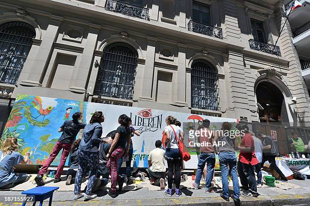 Greenpeace activists paint a mural in front of the Russian embassy in Buenos Aires on November 6 claiming for the release of 30 activists from...