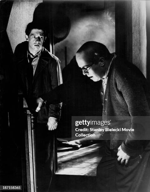 Actors Richard Attenborough and John Hurt in a scene from the film '10 Rillington Place', 1971.