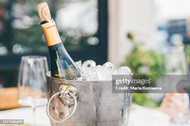 bottle of wine in ice bucket with wine glasses. - ice bucket stock-fotos und bilder