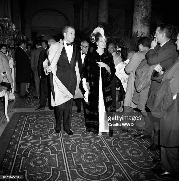 Couple arriving at Truman Capote's Black and White Ball in the Grand Ballroom at the Plaza Hotel in New York City