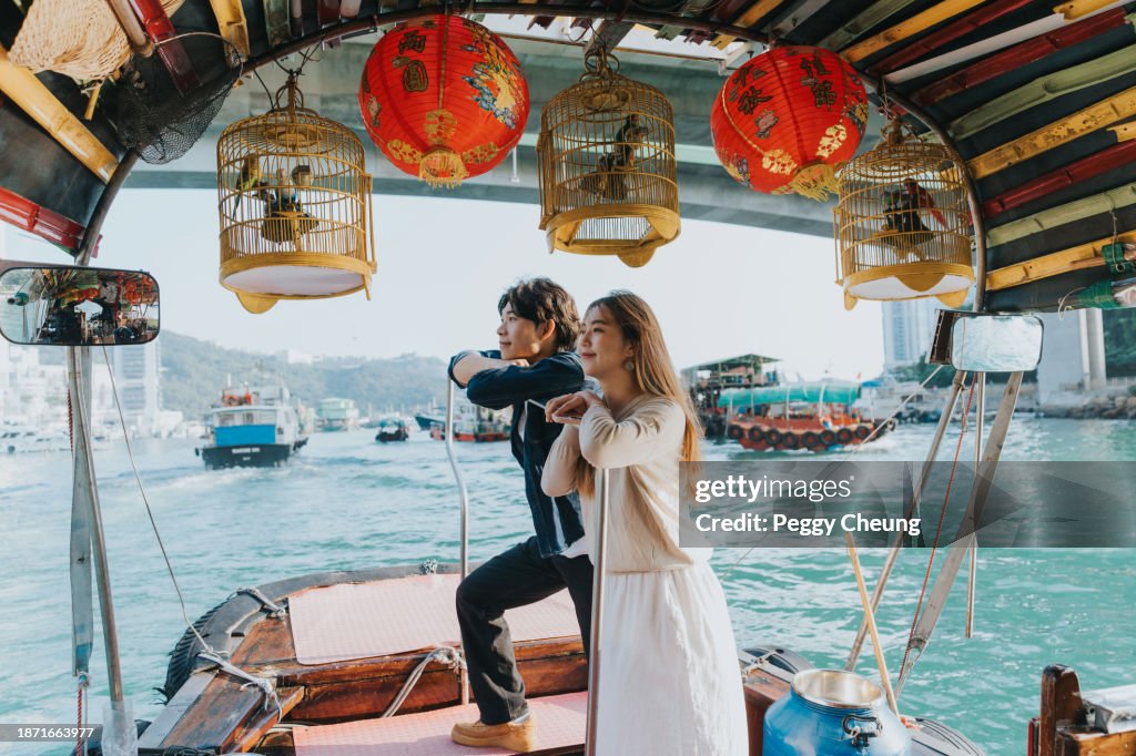 A Chinese couple enjoying the breathtaking view from the Sampan boat
