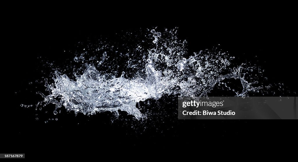 Water splash in midair on black background