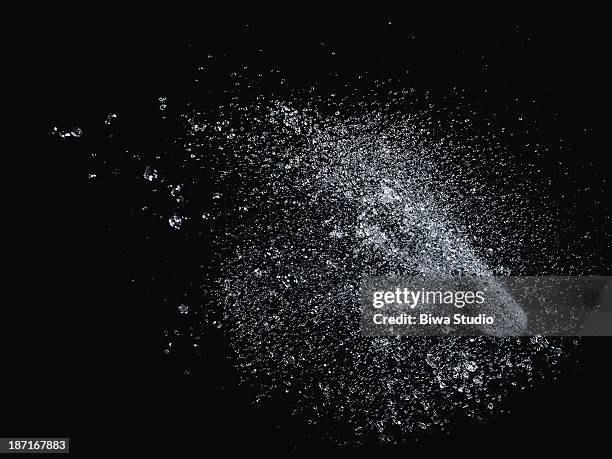 icy water splash in midair on black background - chapinhar imagens e fotografias de stock