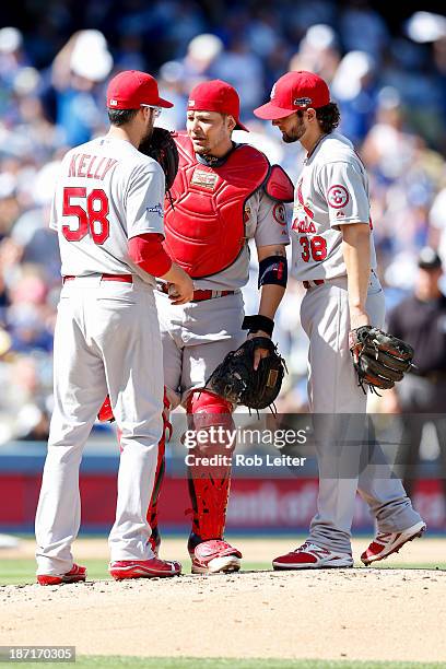 Joe Kelly, Yadier Molina and Pete Kozma of the St. Louis Cardinals talk on the pitchers mound during Game Five of the National League Championship...