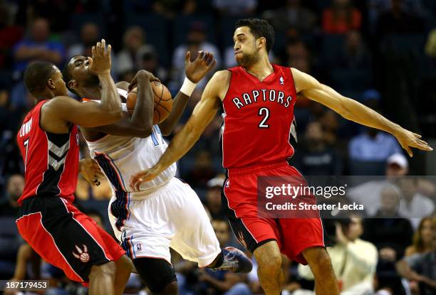 Teammates Landry Fields and Kyle Lowry of the Toronto Raptors run into Michael Kidd-Gilchrist of the Charlotte Bobcats during their game at Time...