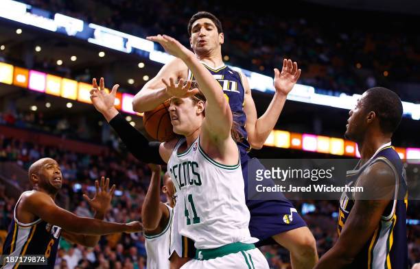 Kelly Olynyk of the Boston Celtics is fouled by Enes Kanter of the Utah Jazz in the second half against the Utah Jazz at TD Garden on November 6,...