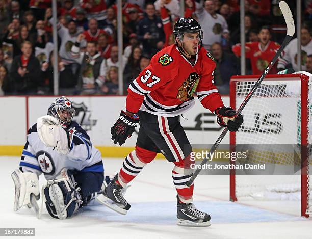 Brandon Pirri of the Chicago Blackhawks celebrates his second period goal as he skates past Al Montoya of the Winnipeg Jets at the United Center on...