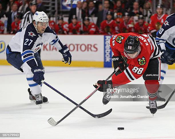Patrick Kane of the Chicago Blackhawks falls to the ice after being tripped by Eric Tangradi of the Winnipeg Jets at the United Center on November 6,...