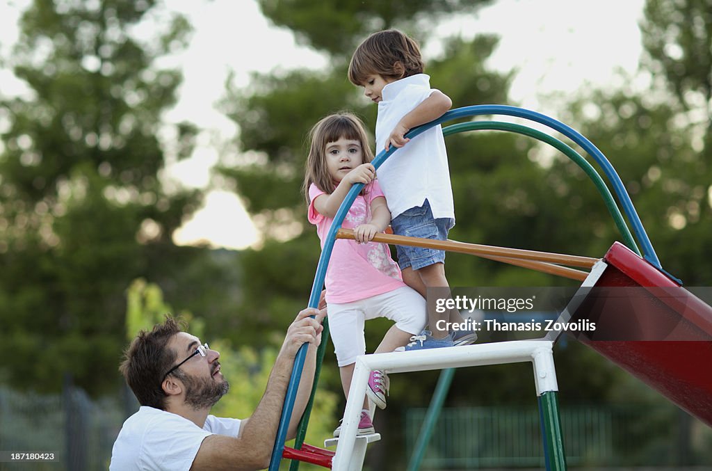 Father with his kids in a playground