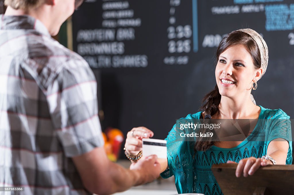 Restaurant cashier reaches for customer card
