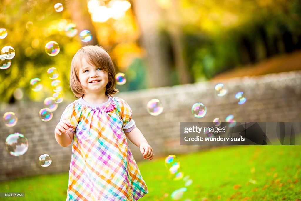 Happy Girl Standing Around Bubbles