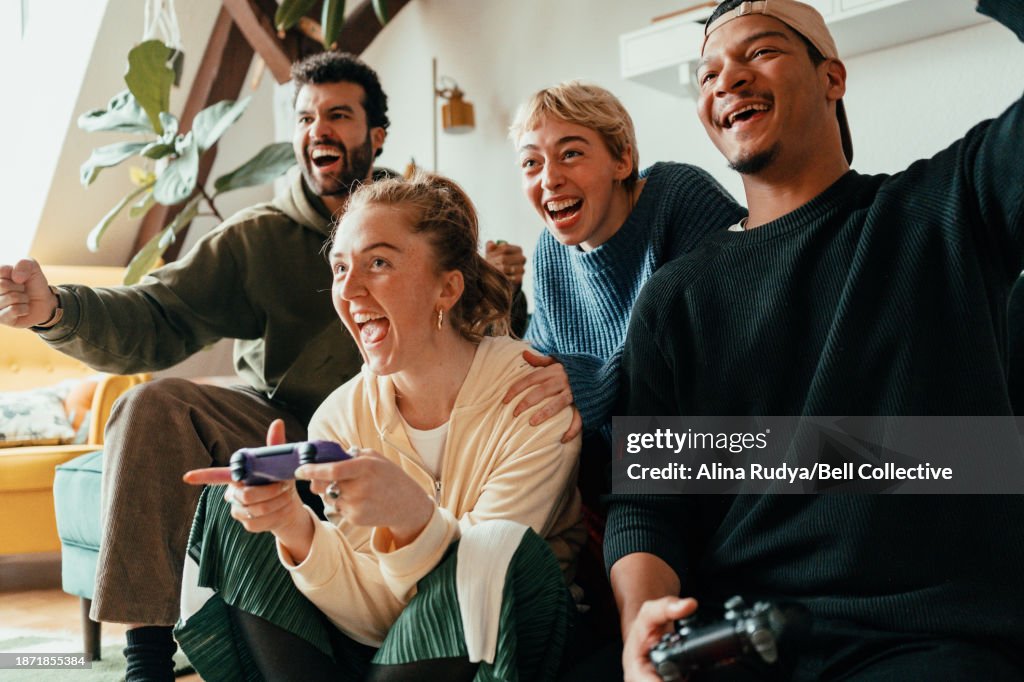 Group of friends playing video games on a console