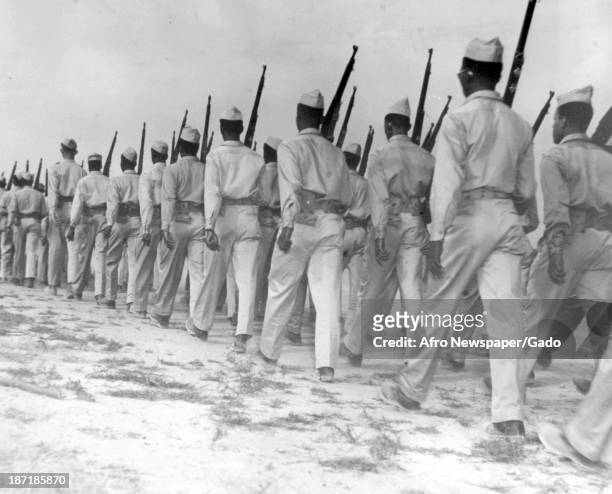 These members of the 514th Quartermaster Training Regiment are truck drivers but they march almost like one man, Camp Pickett, Virgina, 1943....