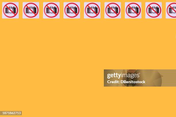 pattern of signs prohibiting taking photos in which a camera and the prohibited sign appear, on top, on a yellow background. concept of prohibition, copyrights, image rights, photography. - health and safety icons stock pictures, royalty-free photos & images