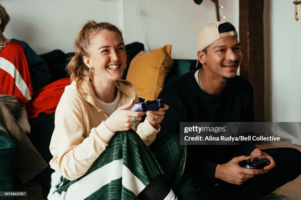 Young couple playing video games on a console