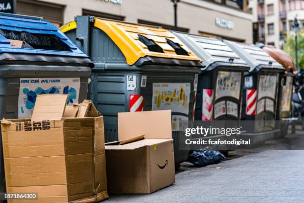 recycling garbage containers in valencia street - glasbak stockfoto's en -beelden