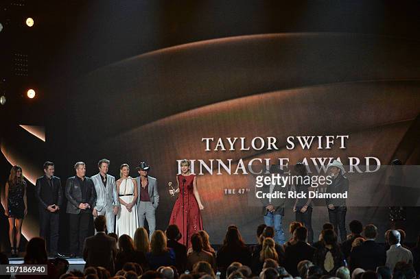 Taylor Swift accepts The CMA Pinnacle Award onstage, presented by Jay DeMarcus, Joe Don Rooney and Gary LeVox of Rascall Flatts, Faith Hill, Tim...