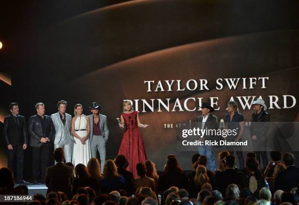 Taylor Swift accepts The CMA Pinnacle Award onstage, presented by Jay DeMarcus, Joe Don Rooney and Gary LeVox of Rascall Flatts, Faith Hill, Tim...