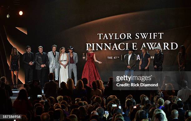 Taylor Swift accepts The CMA Pinnacle Award onstage, presented by Jay DeMarcus, Joe Don Rooney and Gary LeVox of Rascall Flatts, Faith Hill, Tim...