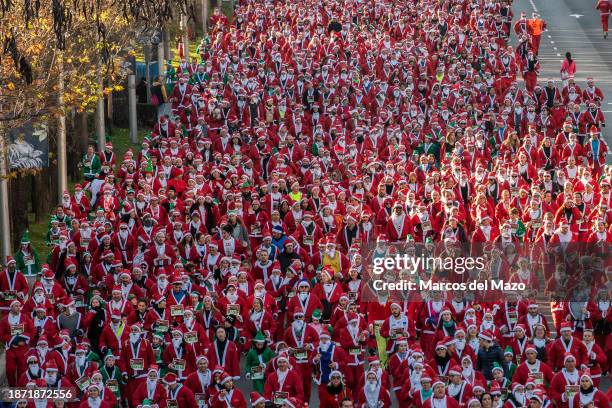 Thousands of people dressed as Santa Claus running during the traditional annual Santa Claus Christmas race.