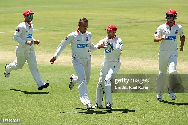 Johan Botha of the Redbacks celebrates the wicket of John Rogers of the Warriors during day two of the Sheffield Shield match between the Western...