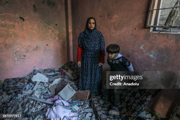 Woman and a child are seen among the rubble of the house of the Palestinian Abu Auf family destroyed as a result of an Israeli attack in Rafah, Gaza...